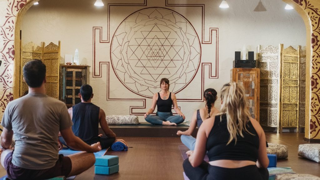 Instructor de pranayama guiando una clase de respiración consciente en formación profesional online